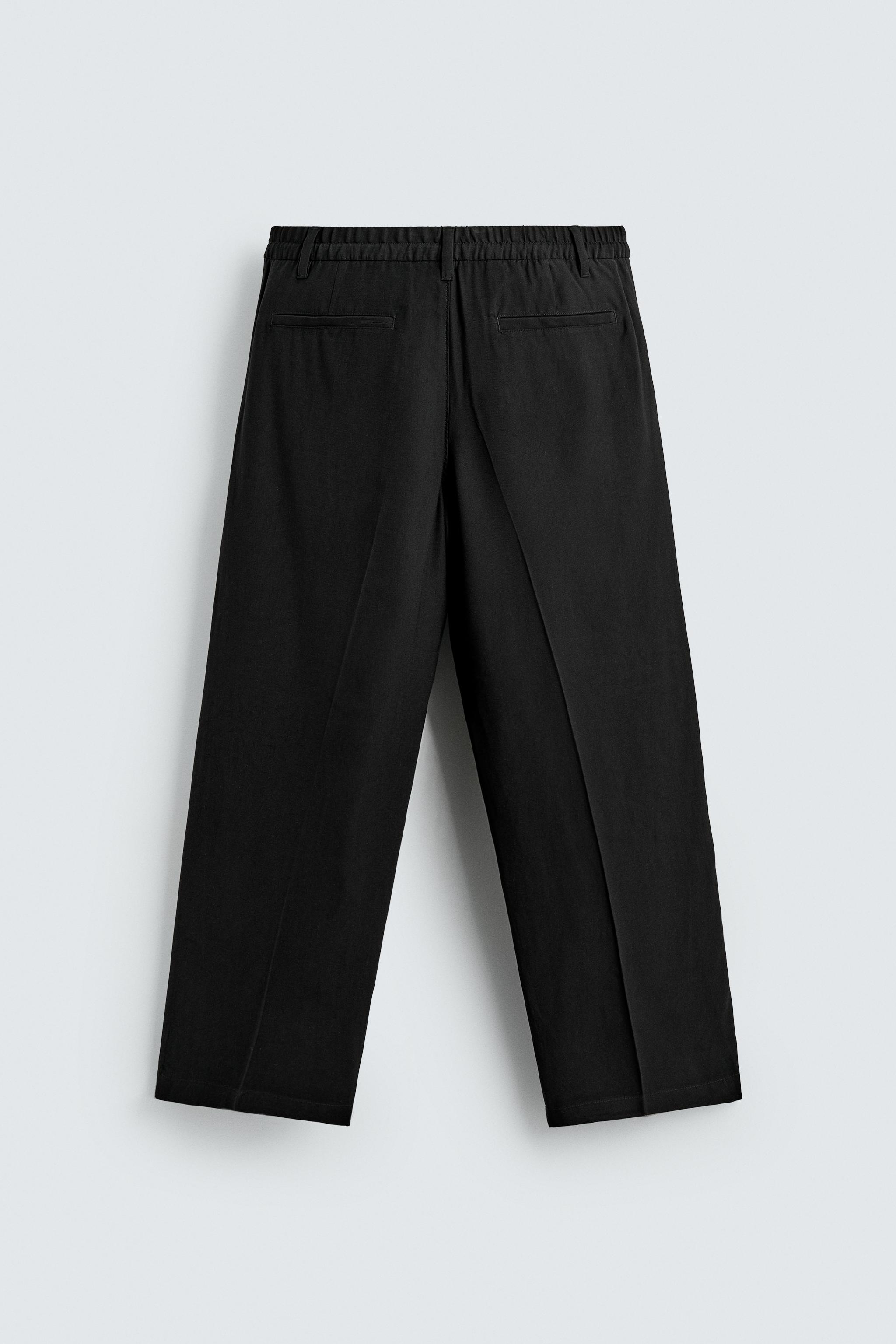 FLOWY RELAXED FIT PLEATED PANTS